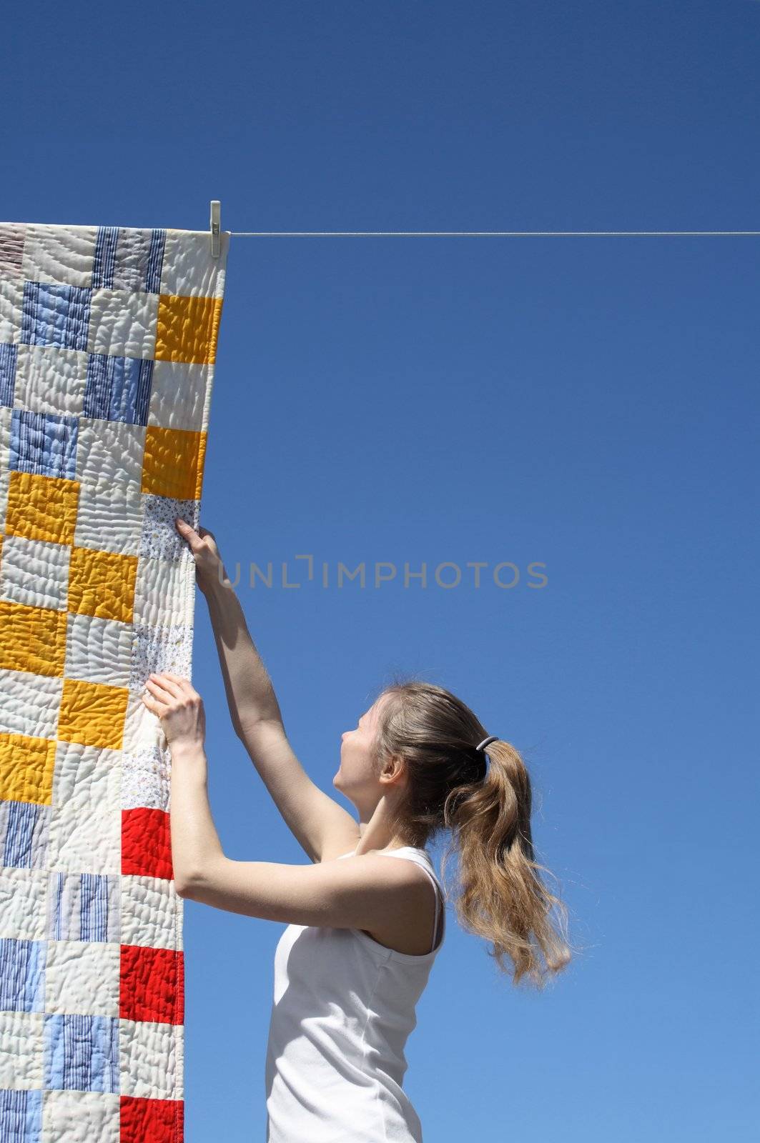 Young woman and bright laundry by anikasalsera