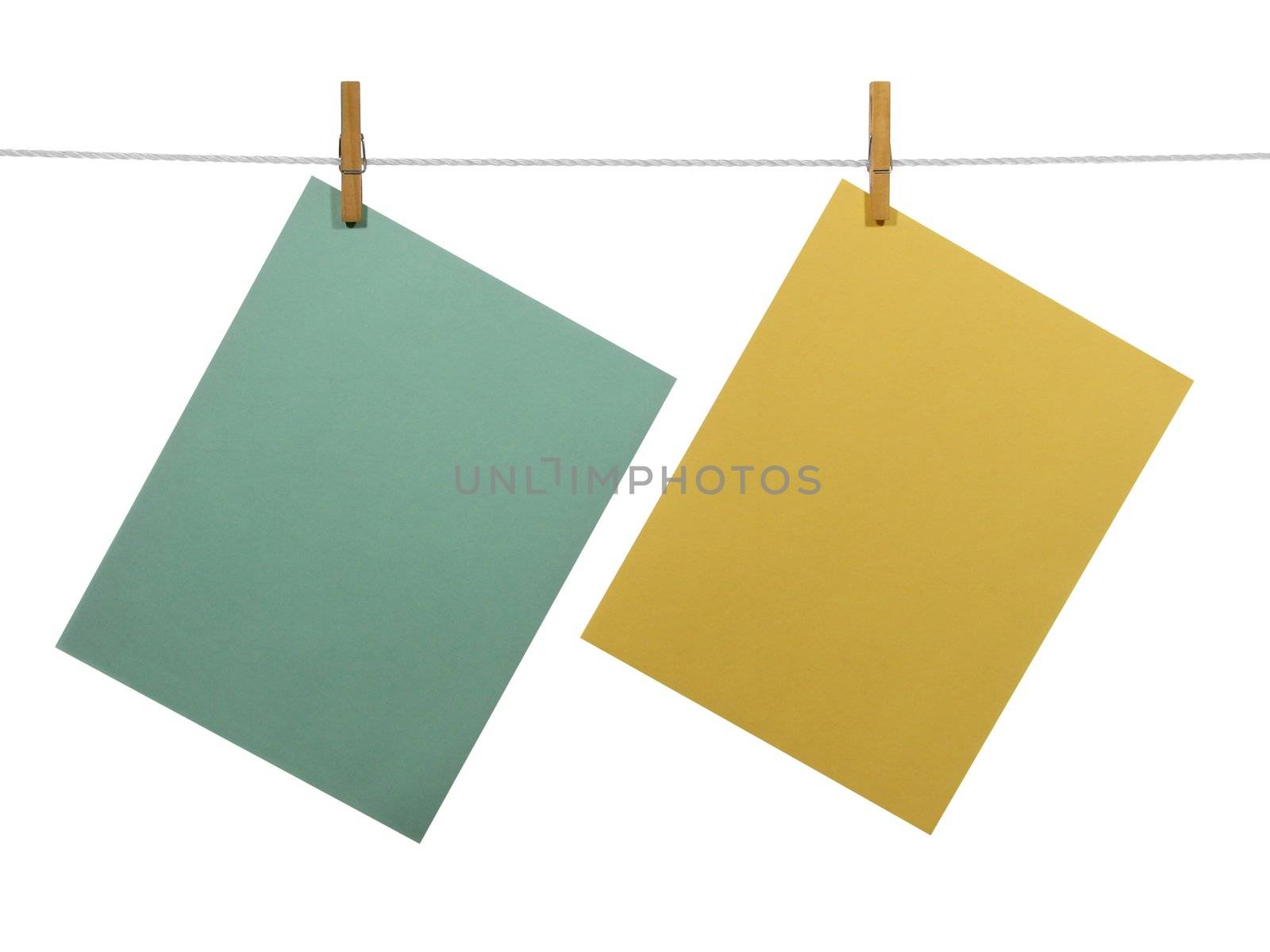 Green and yellow blank paper sheets on a clothes line, isolated on white background. With clipping path.