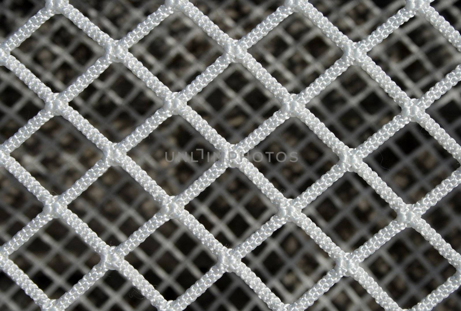 Closeup of a new hockey goal net, forming a symmetric pattern.