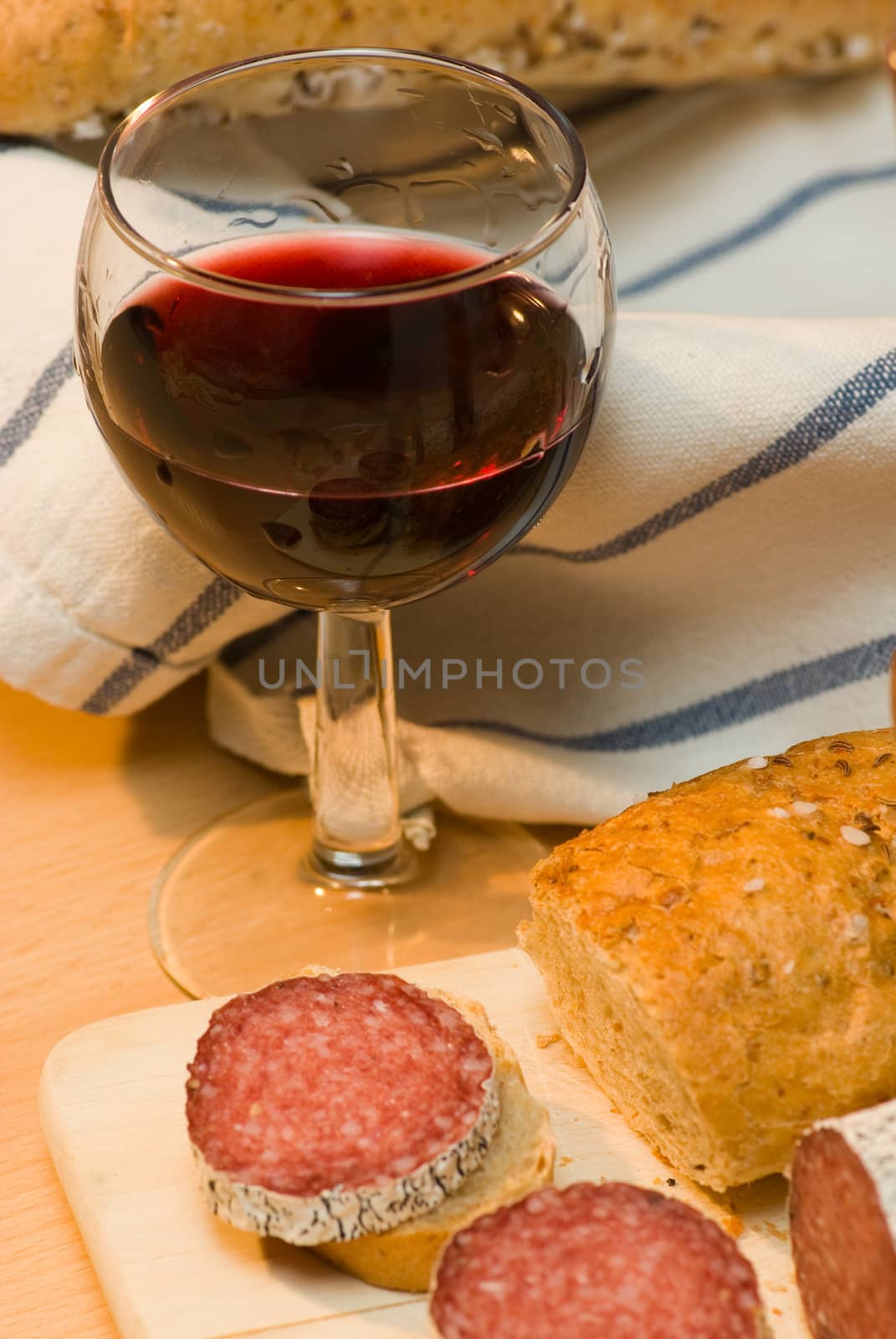 still life with red wine,sausage and bread roll