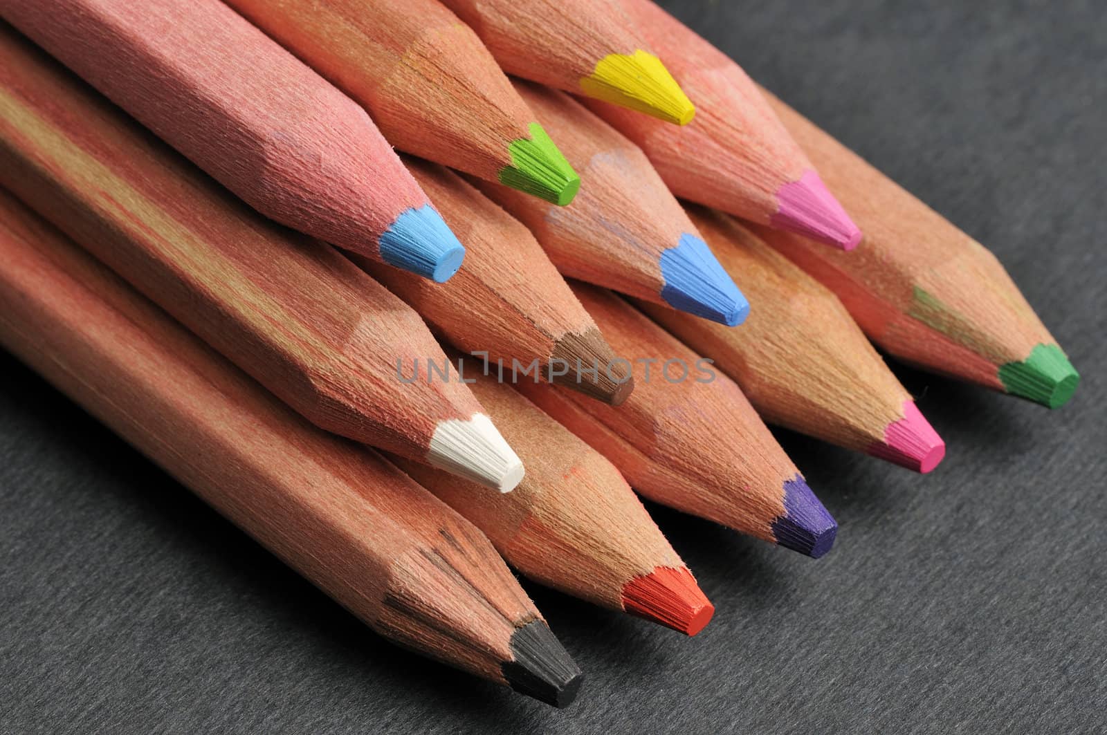 Colored pencils against black background