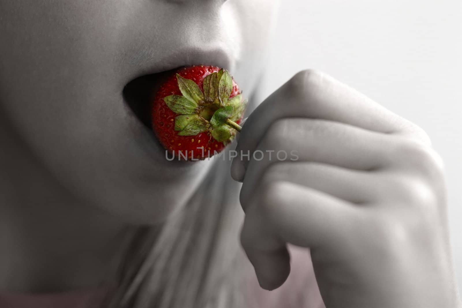The girl eats strawberry