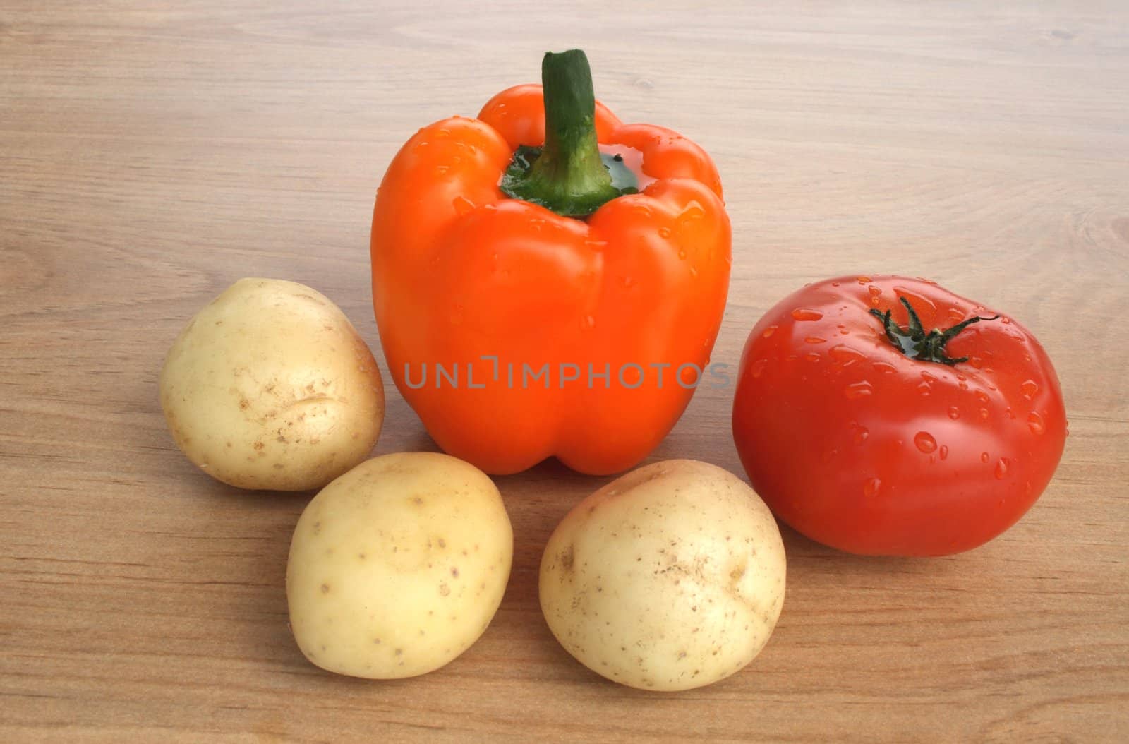 Fresh vegetables. Sweet orange pepper, tomato and potatoes.