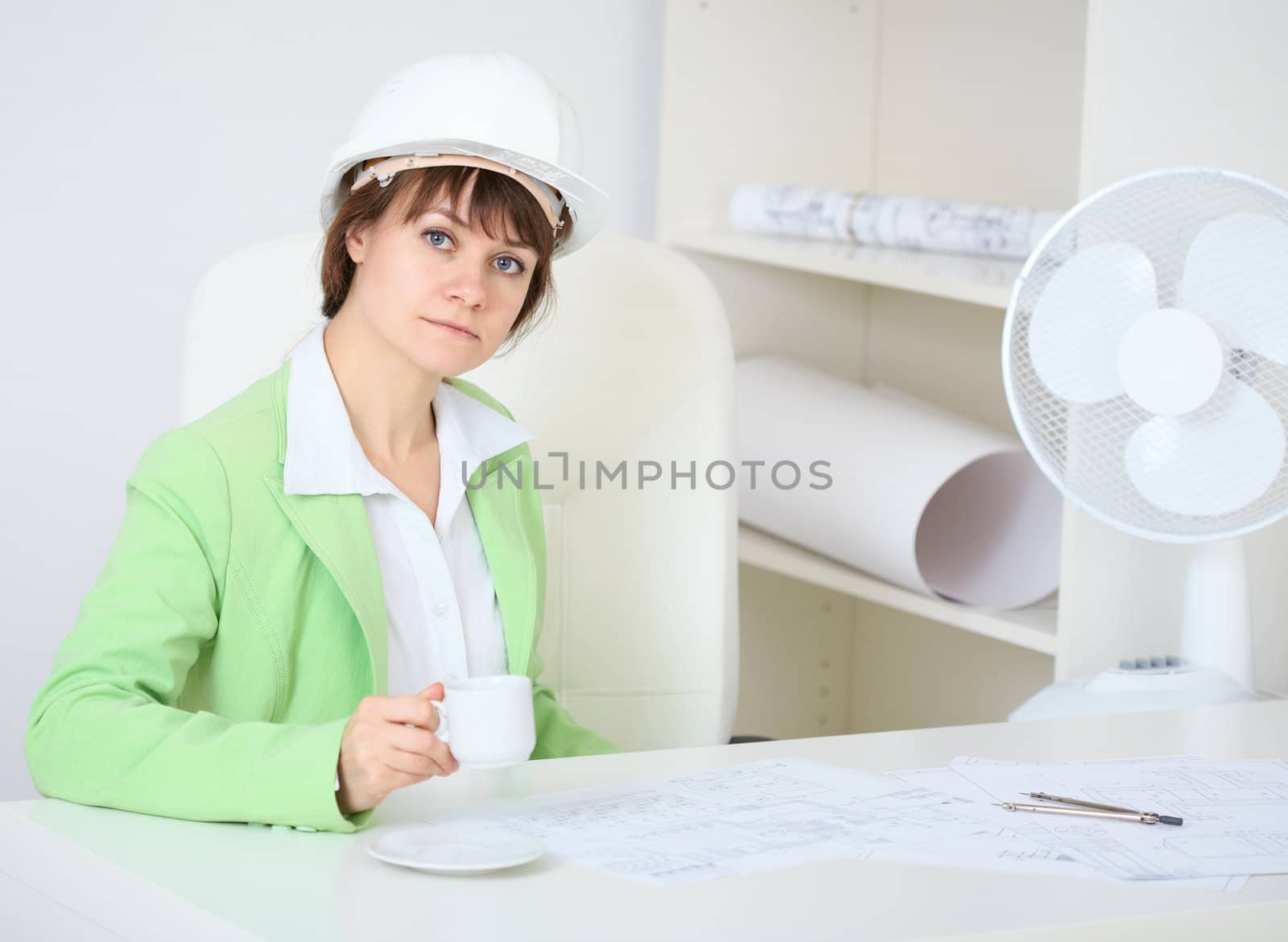 Woman - a builder in helmet with cup in hand by pzaxe