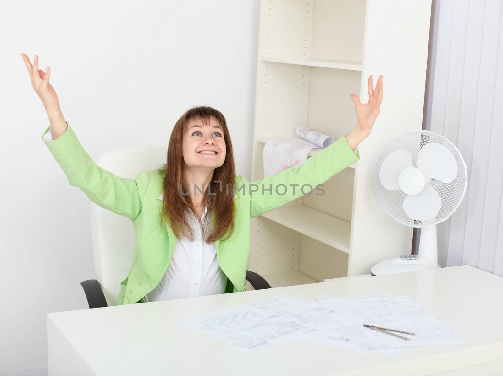 Jubilant woman at his workplace in office by pzaxe