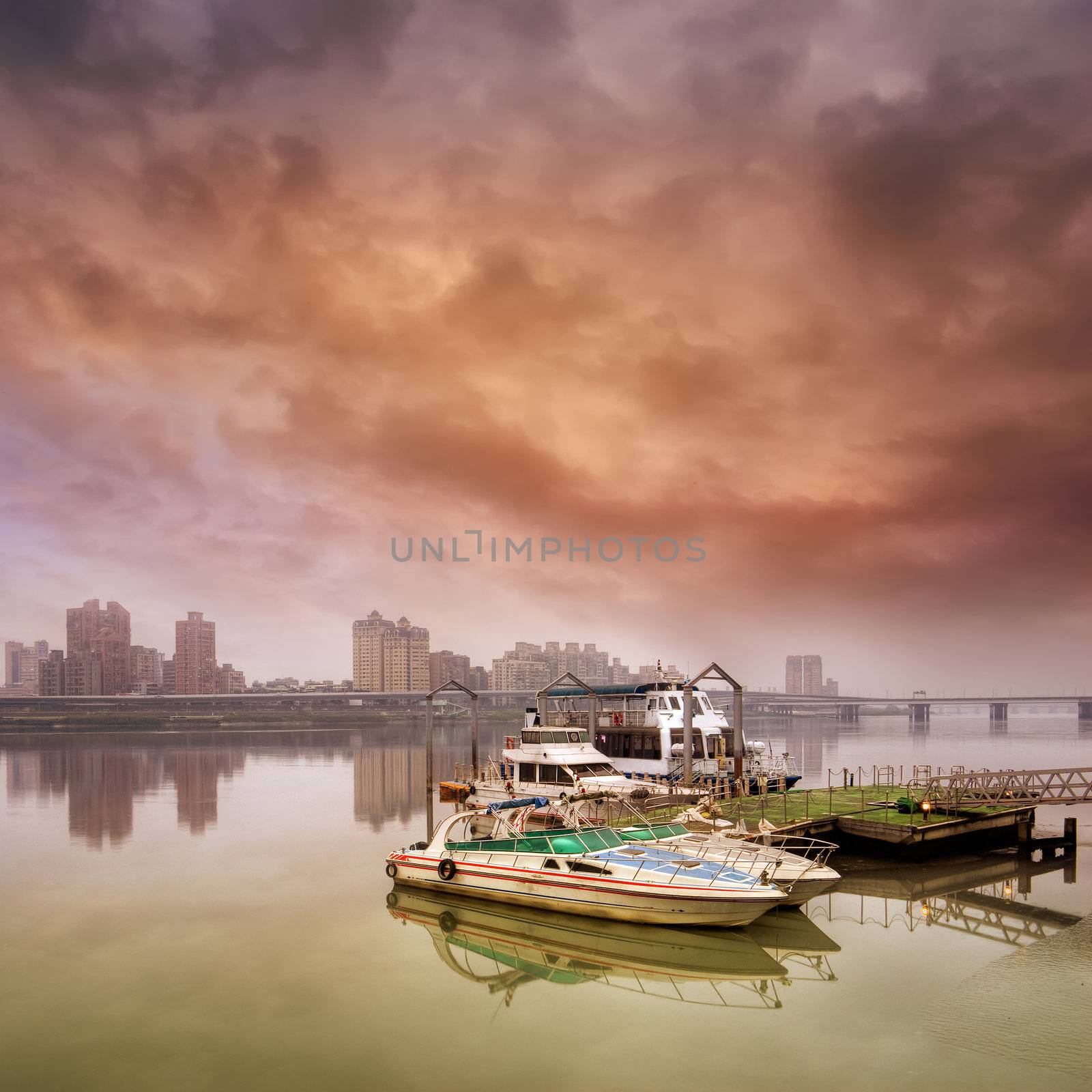 Dramatic landscape of boat on harbor against bad weather.