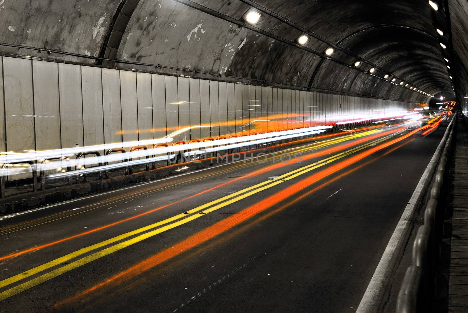 Cityscape of tunnel with color of car light.