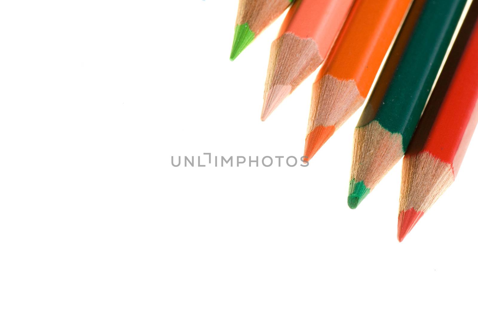 Color wooden pencils lay on white background.