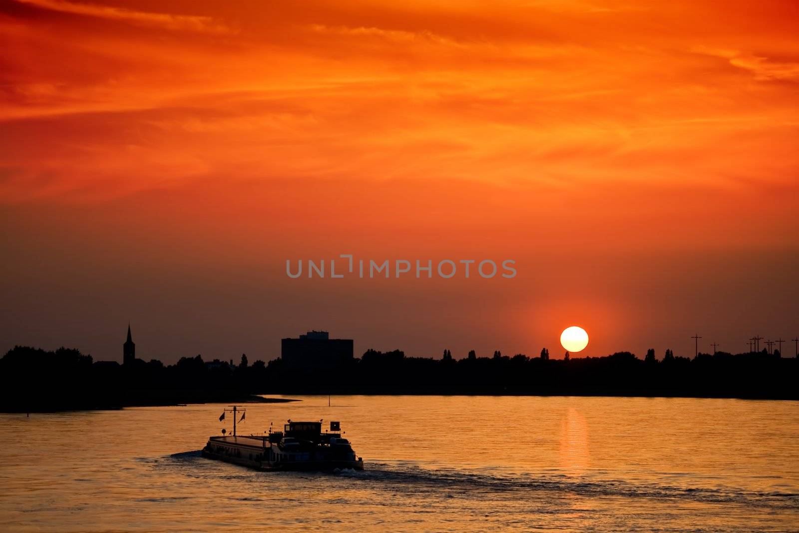 Barge with cargo at sunset