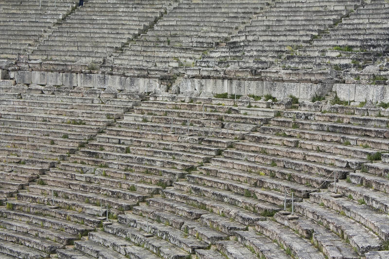 Close up of stone seats in Greek ancient theatre of Epidauros.