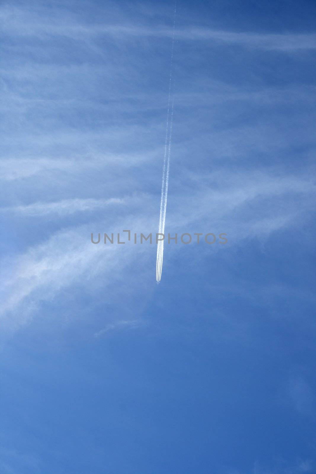 Trace of a jet airplane crossing the sky like a comet.