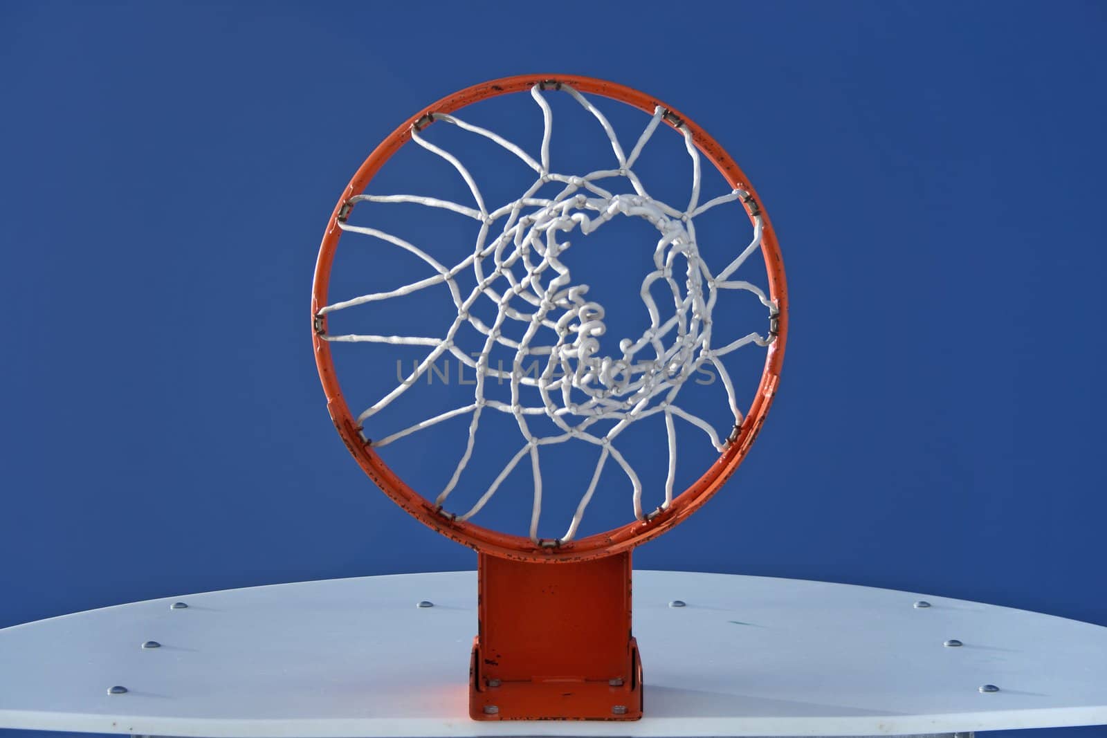 Orange basketball hoop and the blue sky by anikasalsera