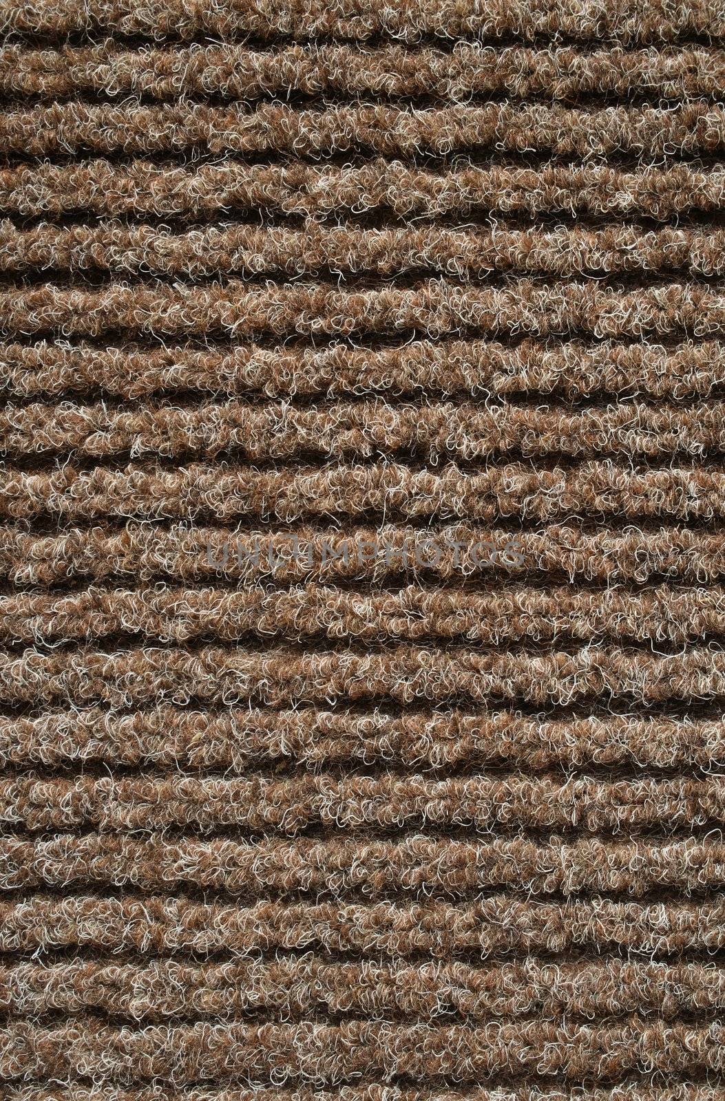 Texture of a brown striped fabric of a carpet.