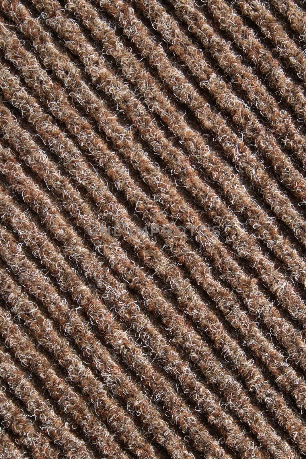 Diagonal lines of a brown striped fabric of a carpet.