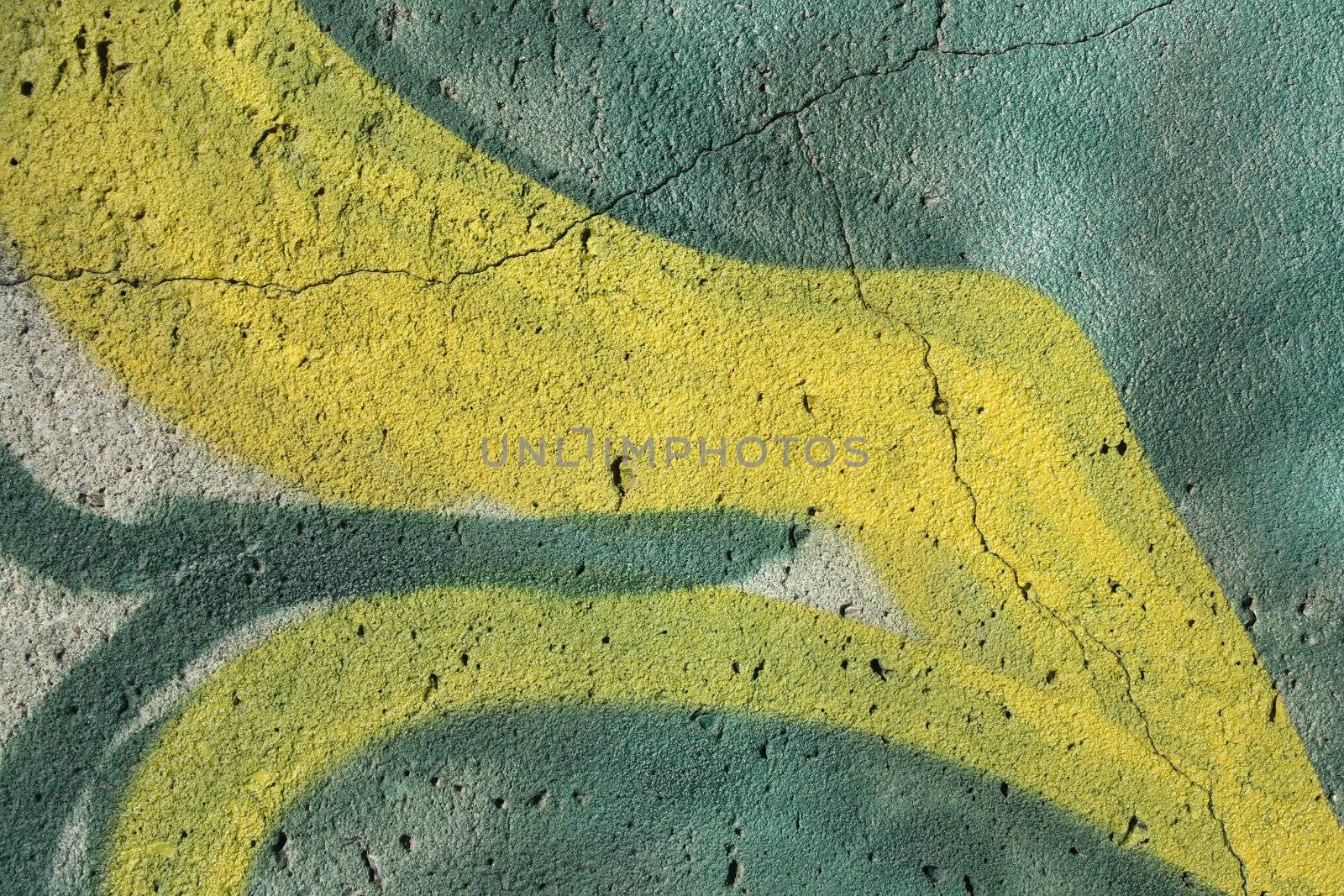 Abstract background: detail of a graffiti on a cracked concrete wall.