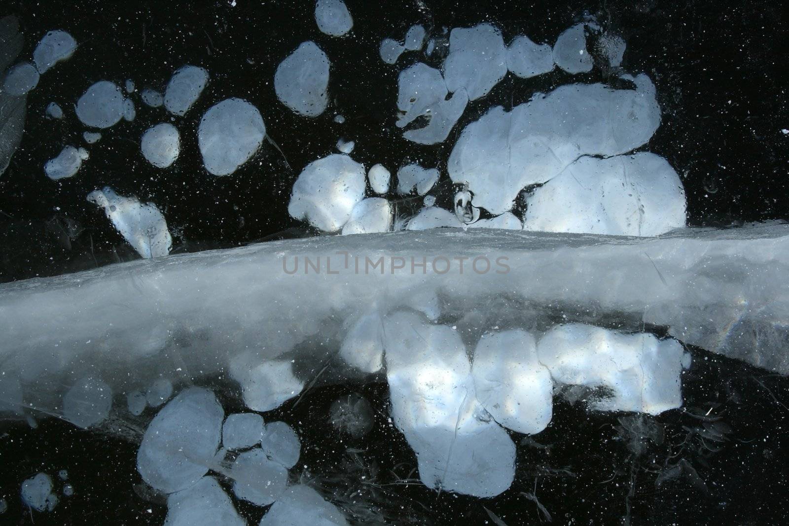 Intricate pattern of frozen water. Frozen air bubbles in ice.