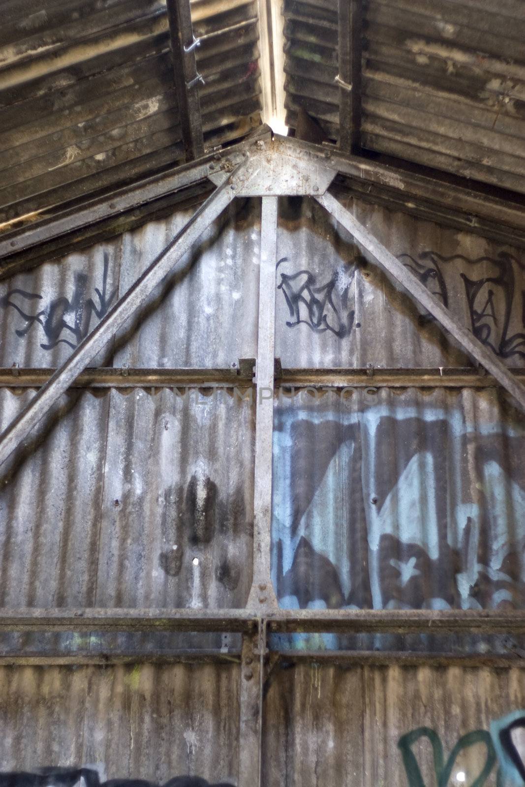 An old structure that is covered with graffiti.