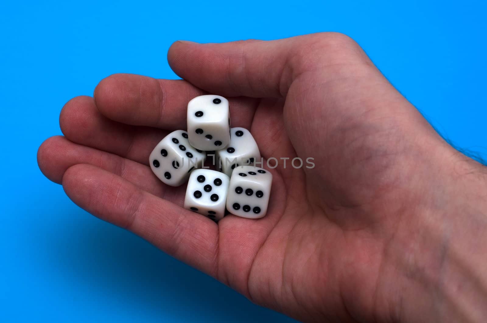 Game cubes in a hand before a throw on good luck