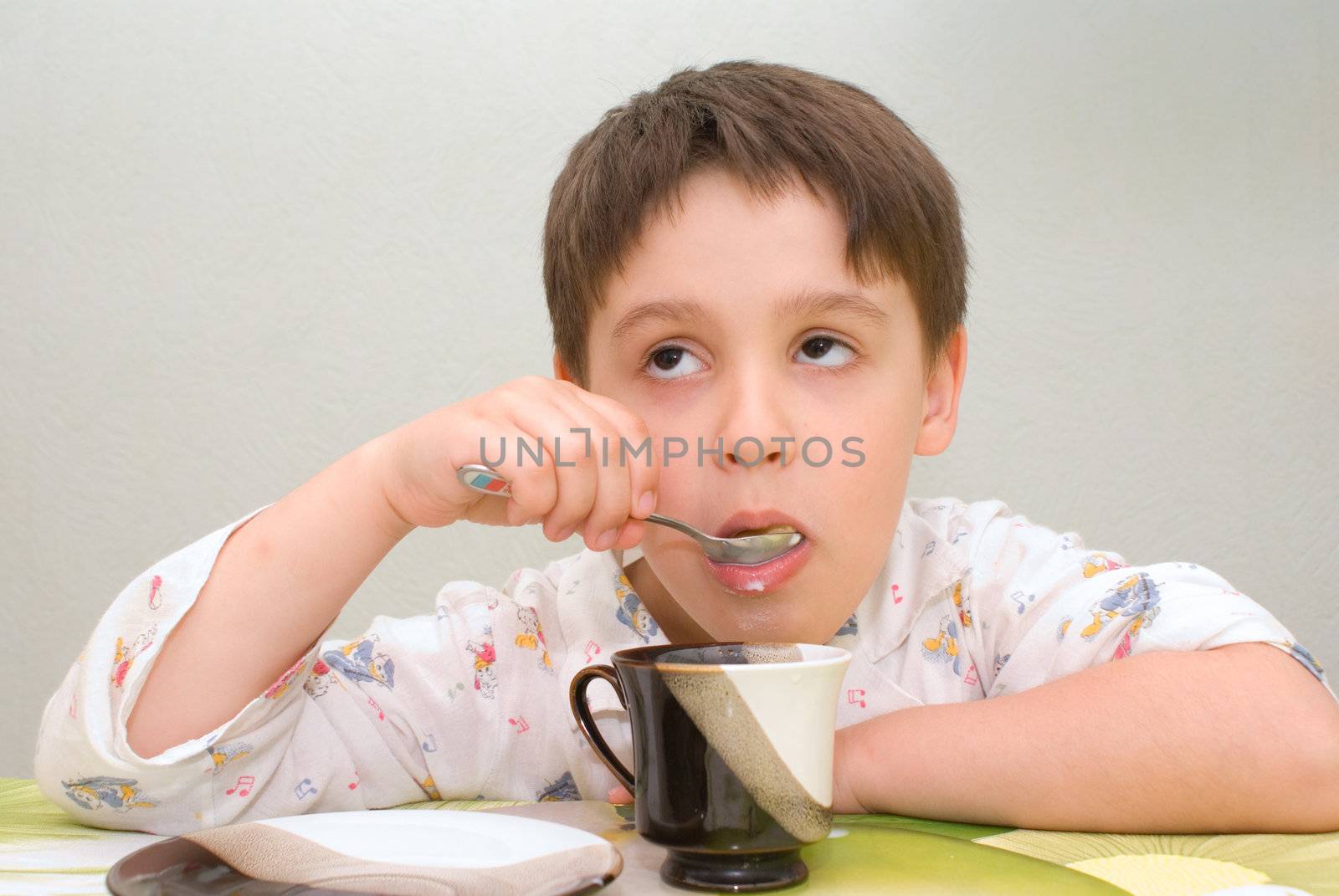 Boy unwillingly eating milk from a cup