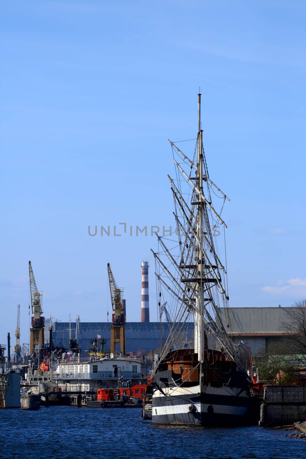 Sailing ship at the port take off mast. River Neva, Saint-Petersburg, Russia.