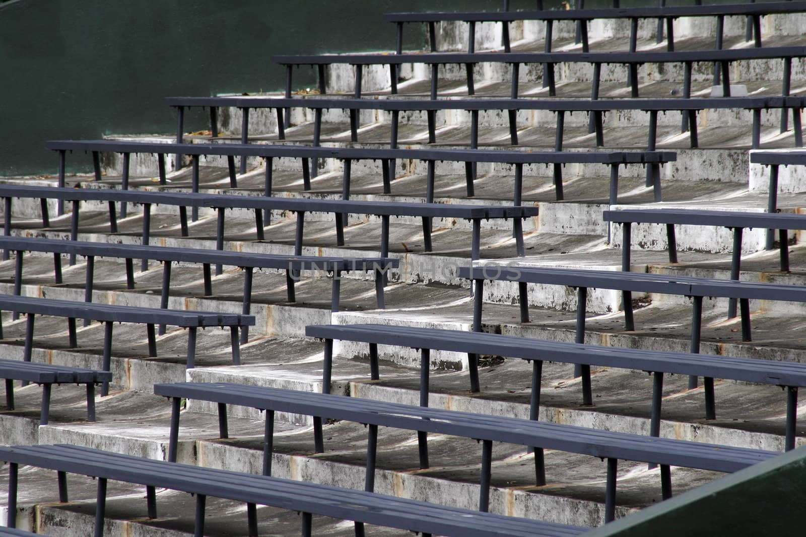 Blue Benches On A Grey Concrete Ground In Rows, Stadium Seats