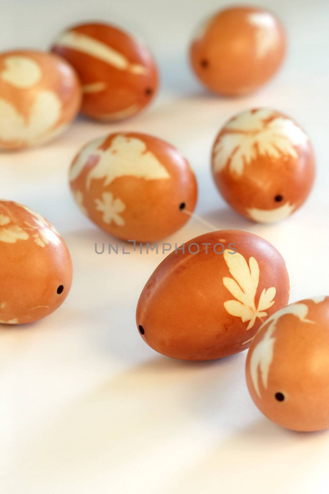 Easter eggs that have been stained with onion skins and leaves. Shallow depth of field focusing on the middle egg.
