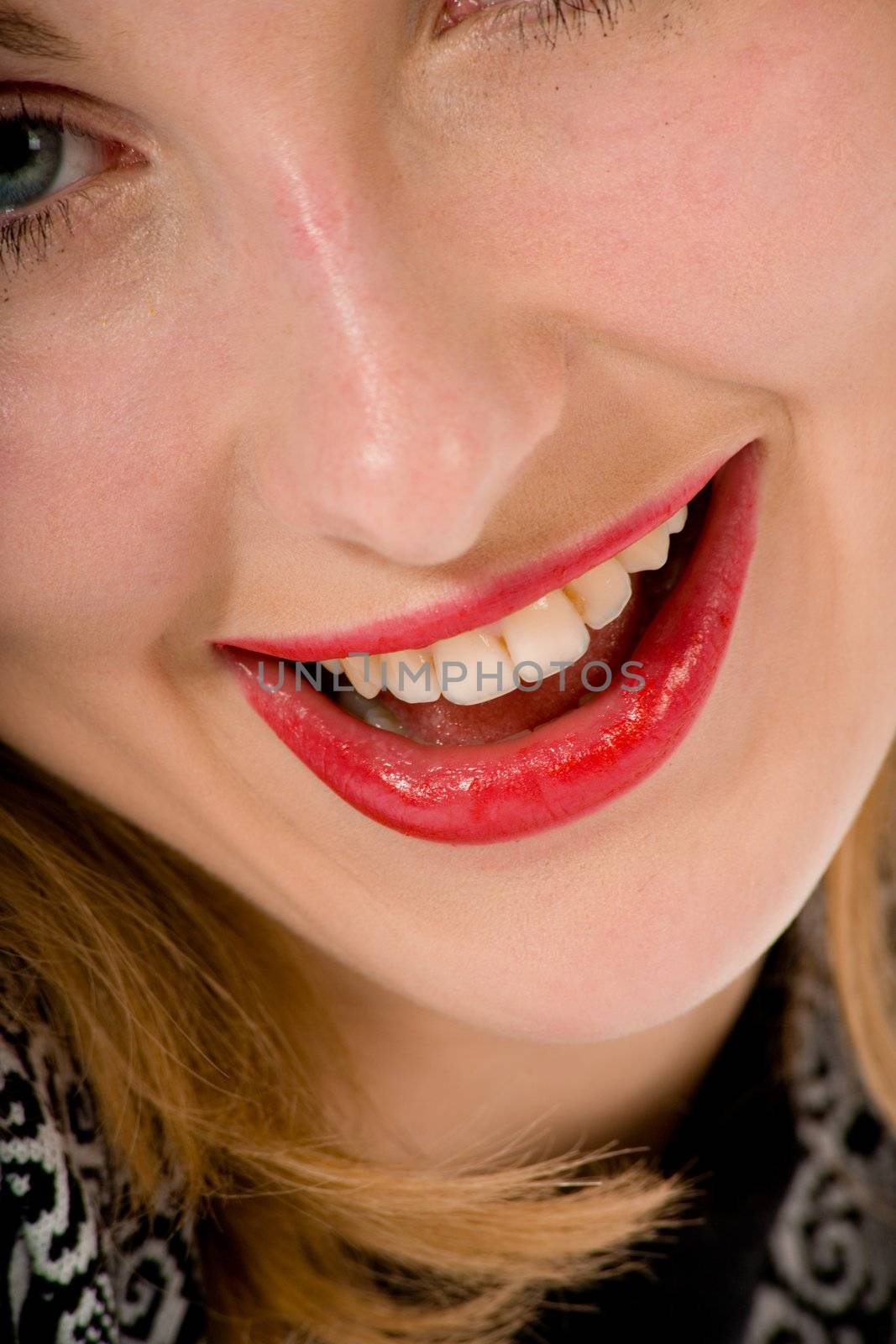 Smile of a beautiful young woman on white background