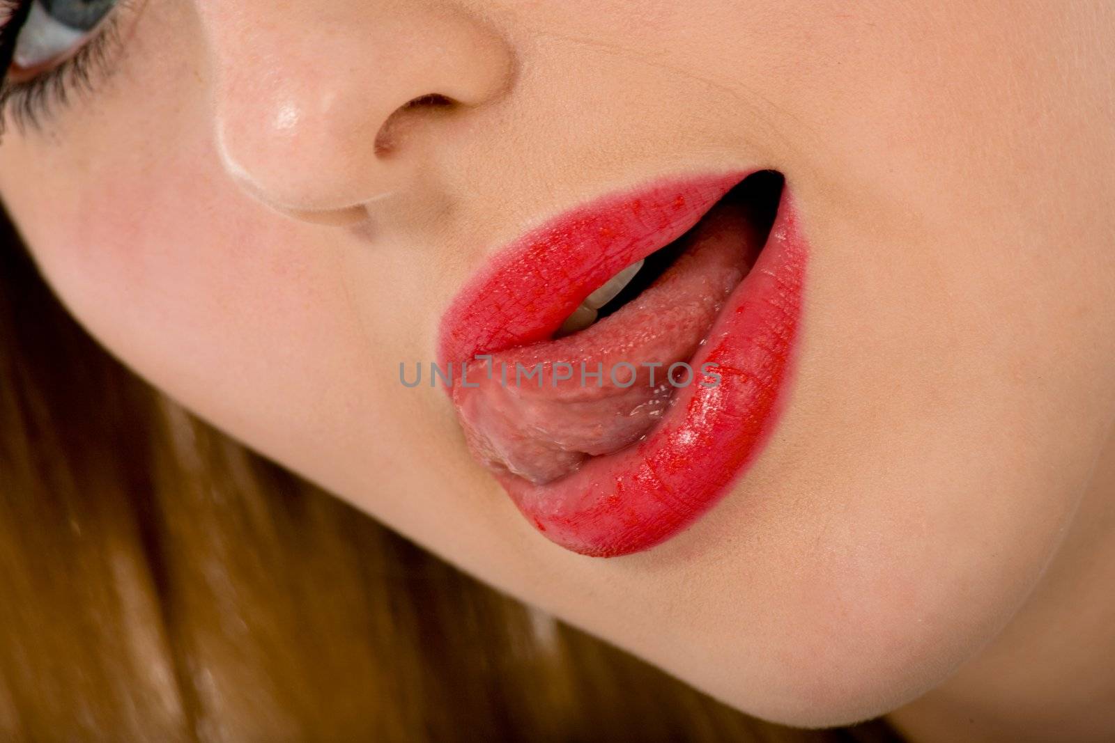 Beautiful woman leaking teeth with tongue close-up