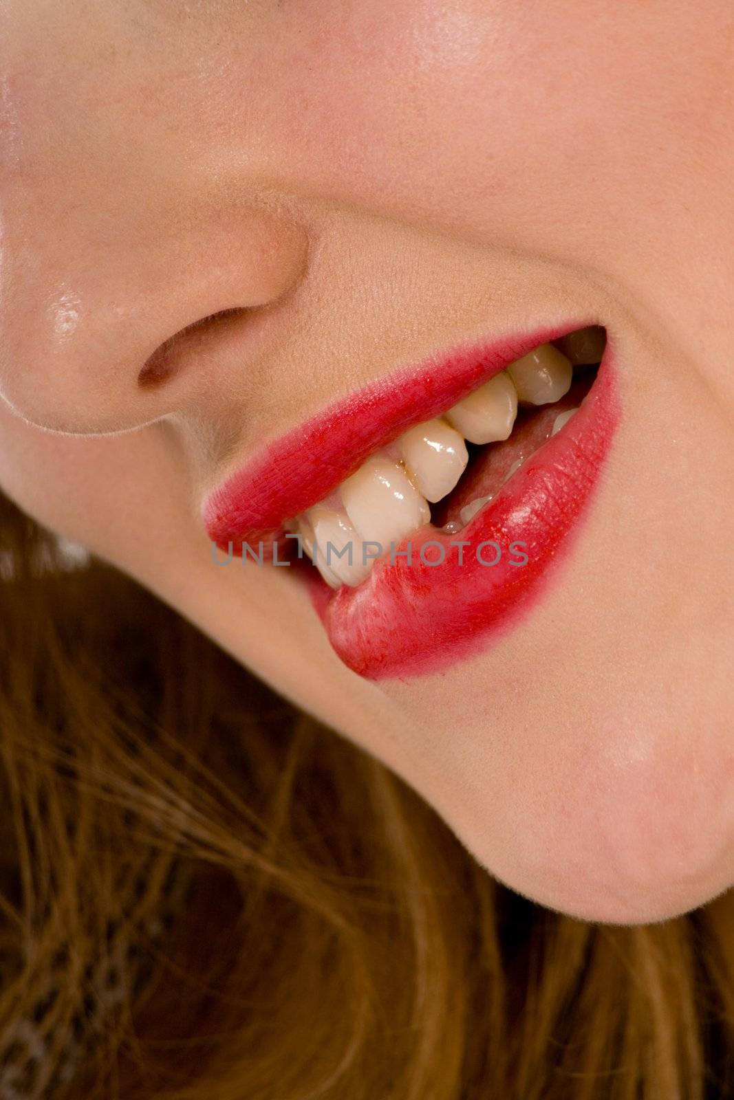 Smile of a beautiful young woman on white background