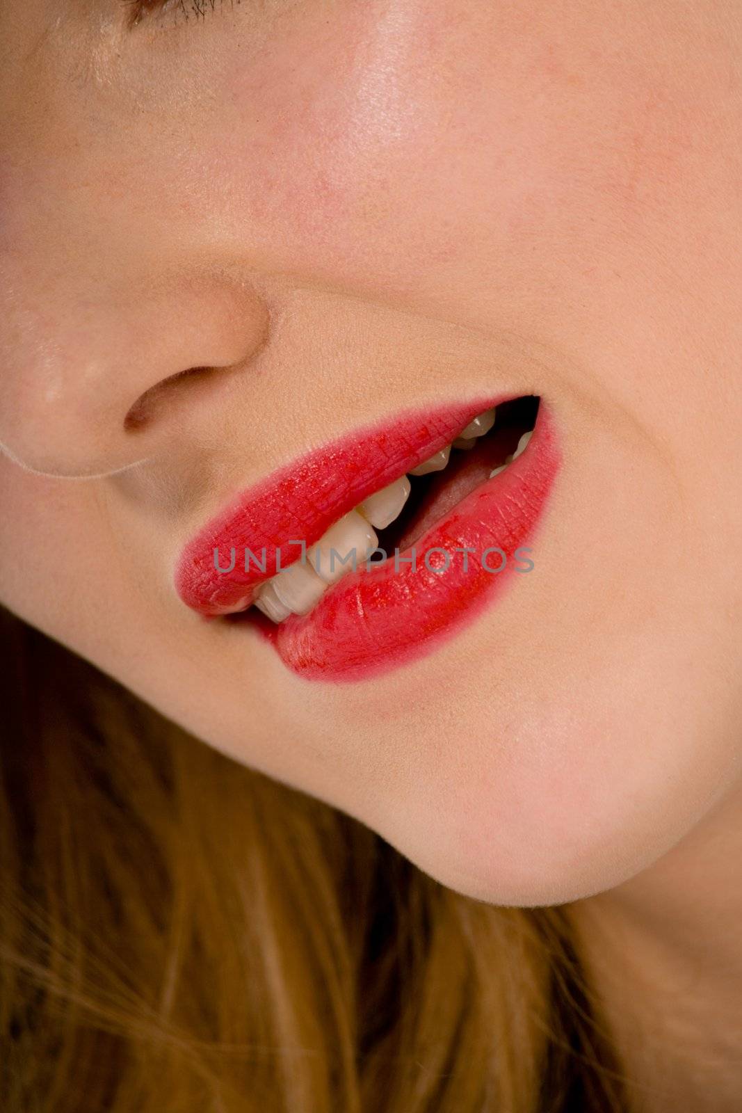 Smile of a beautiful young woman on white background