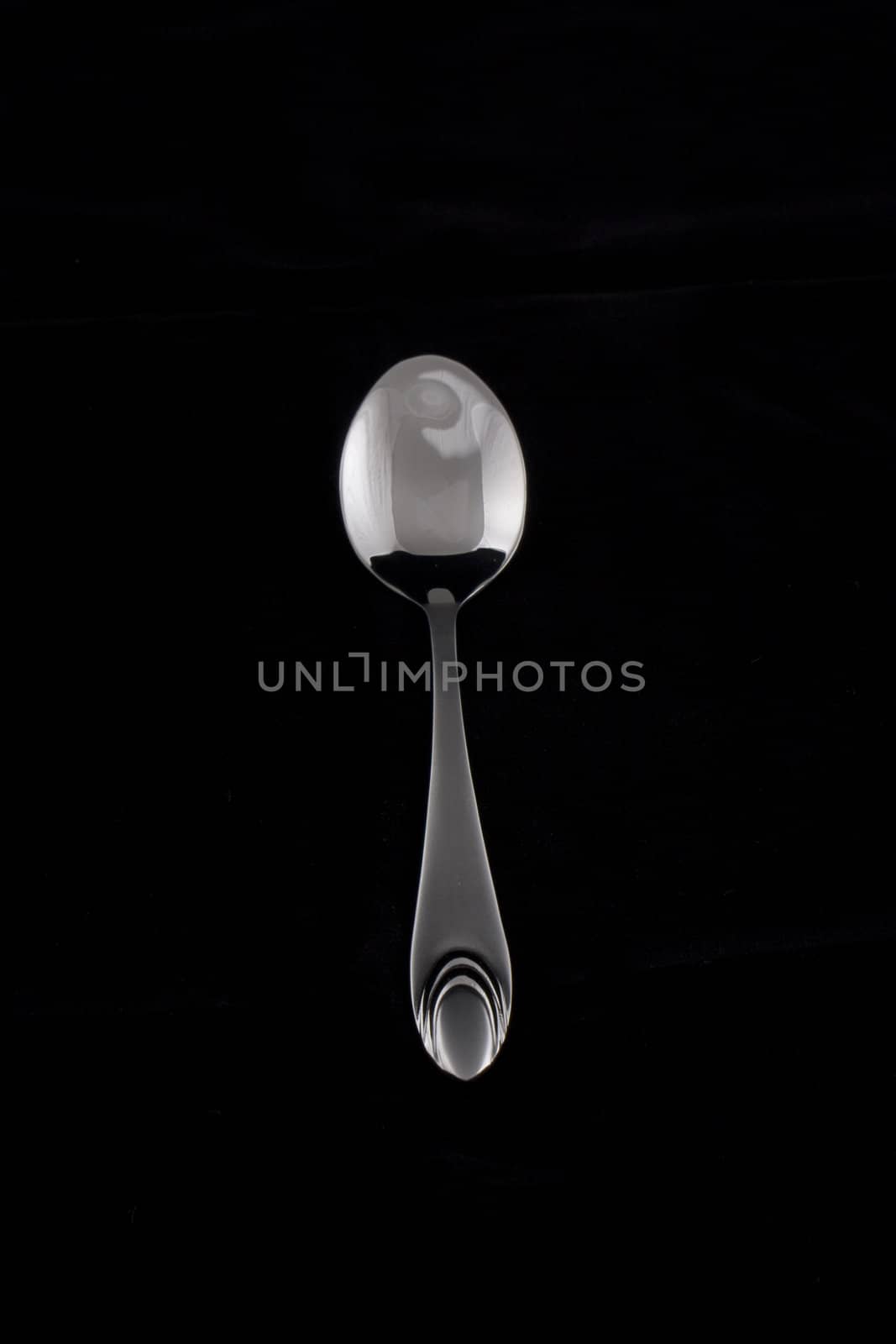 tea-spoon on black background