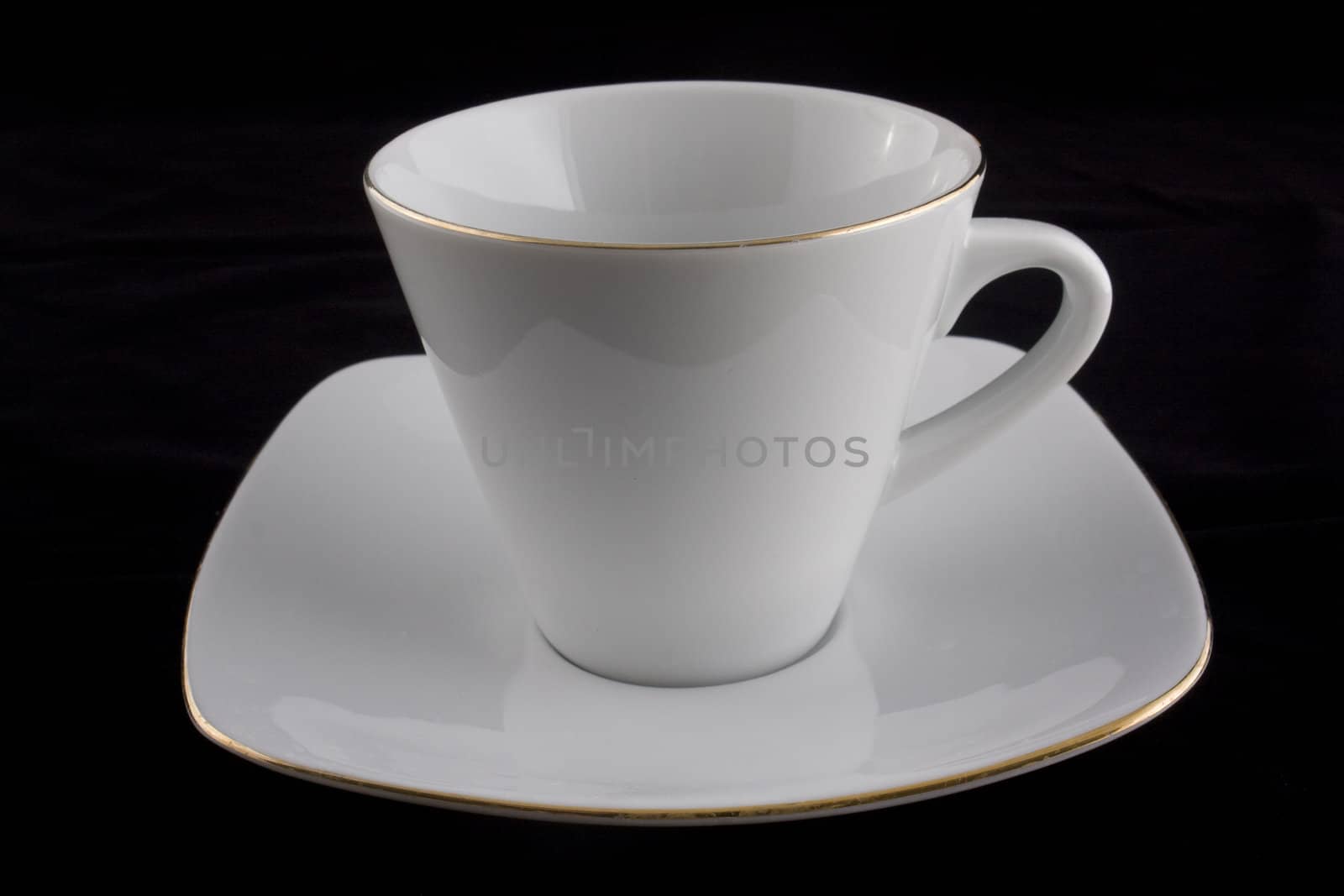 white cup on black background