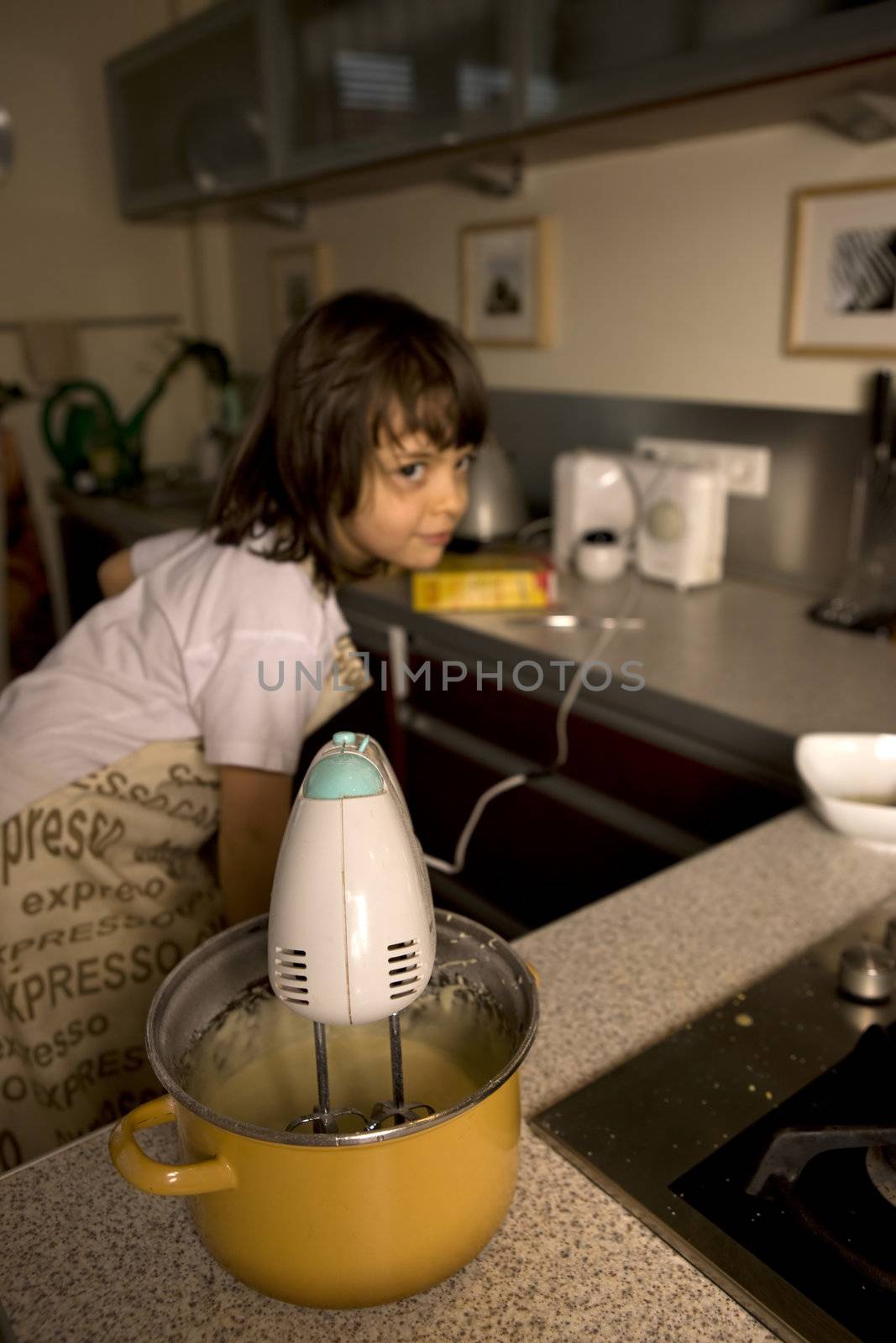  young girl having fun in the kitchen making cookies