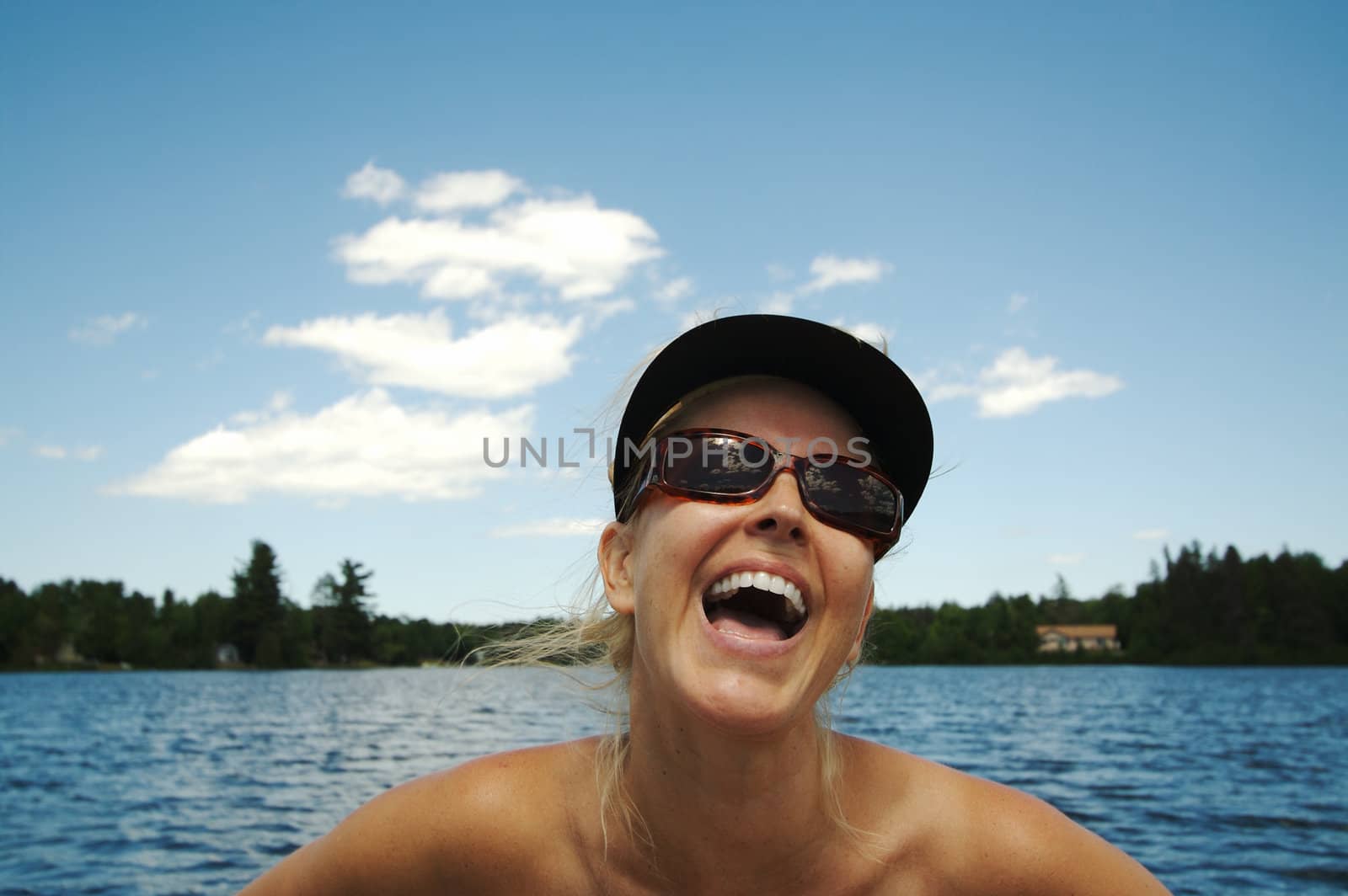 Beautiful woman enjoys a summer day on the lake.