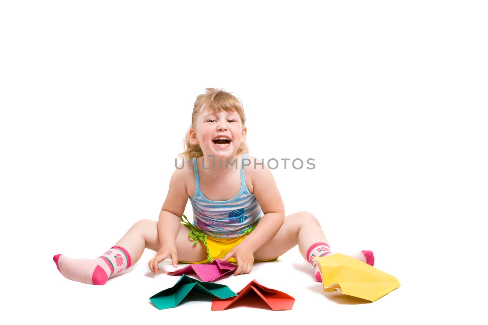 baby playing with made-hands paper airplane and very happy from her work