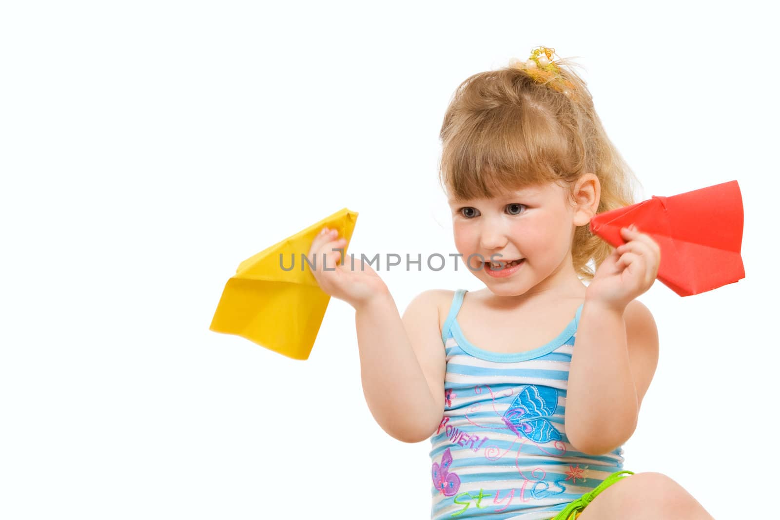 a small baby plaing with red and yellow paper airplane made hands