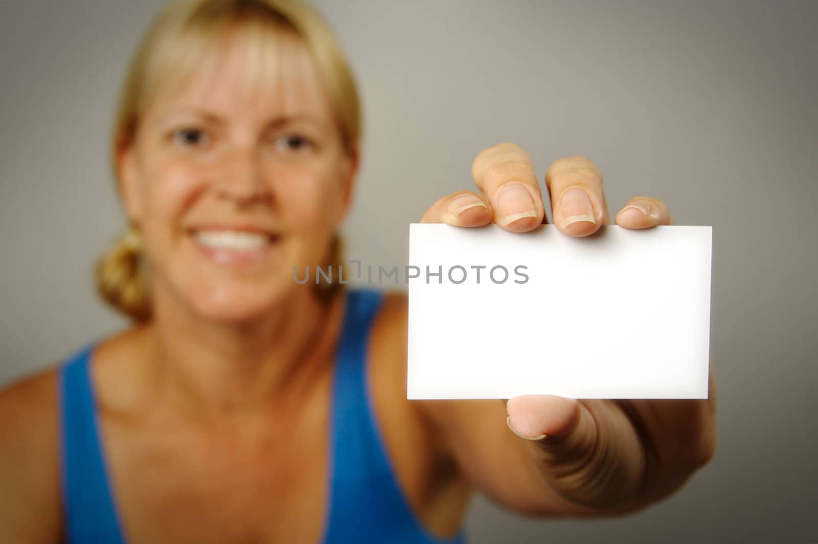 Smiling Woman Holding Blank Business Card. Room for text, or your own message.