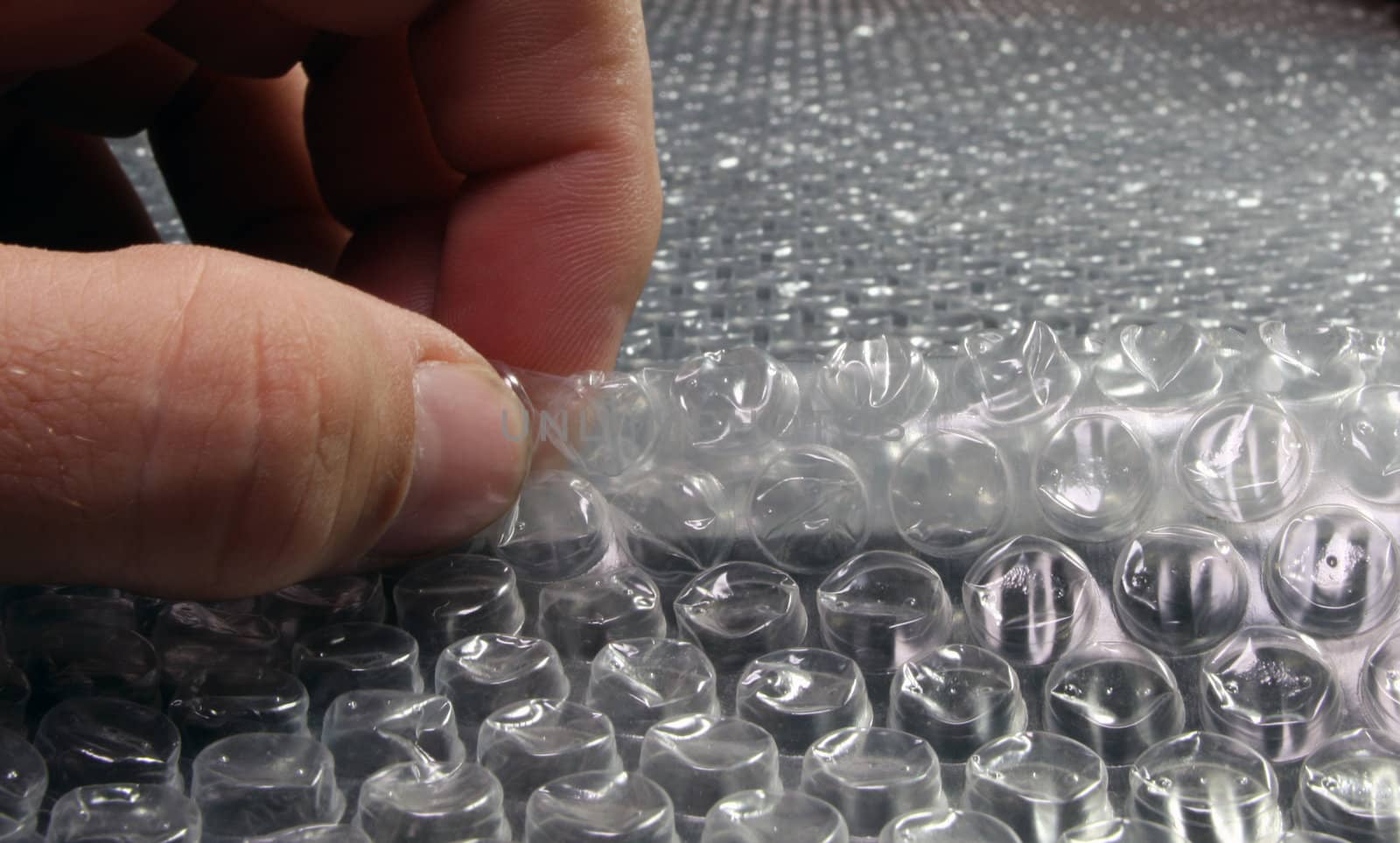 Someone popping bubbles in bubble wrap