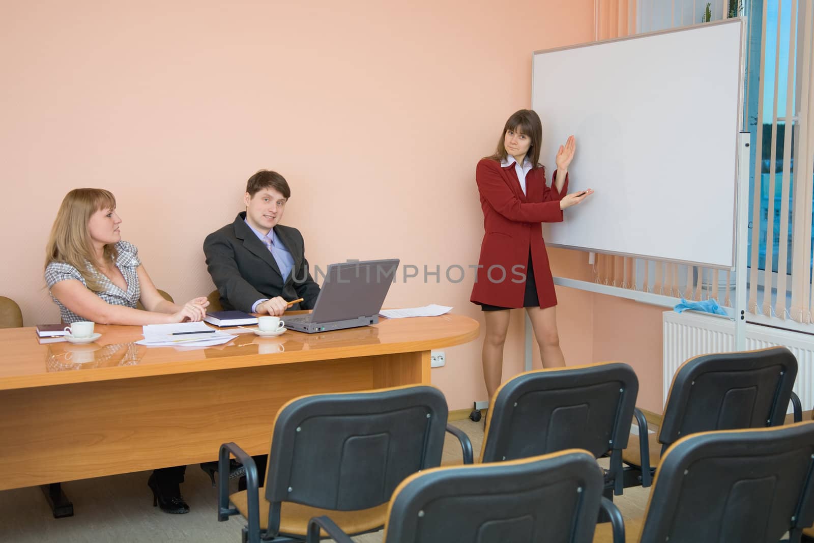 Girl passing exams standing near a big screen
