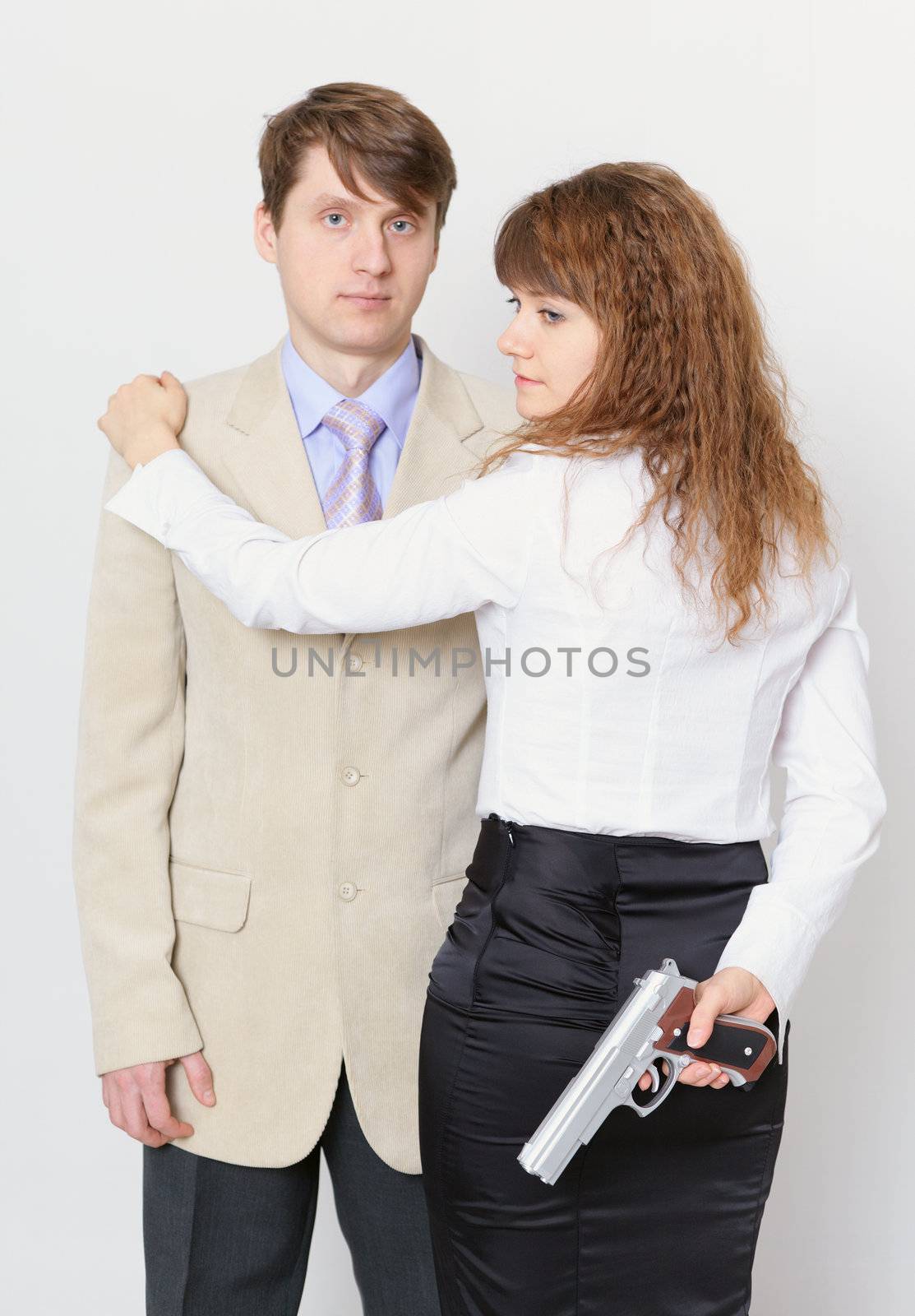 A young man and a beautiful woman with gun in hand