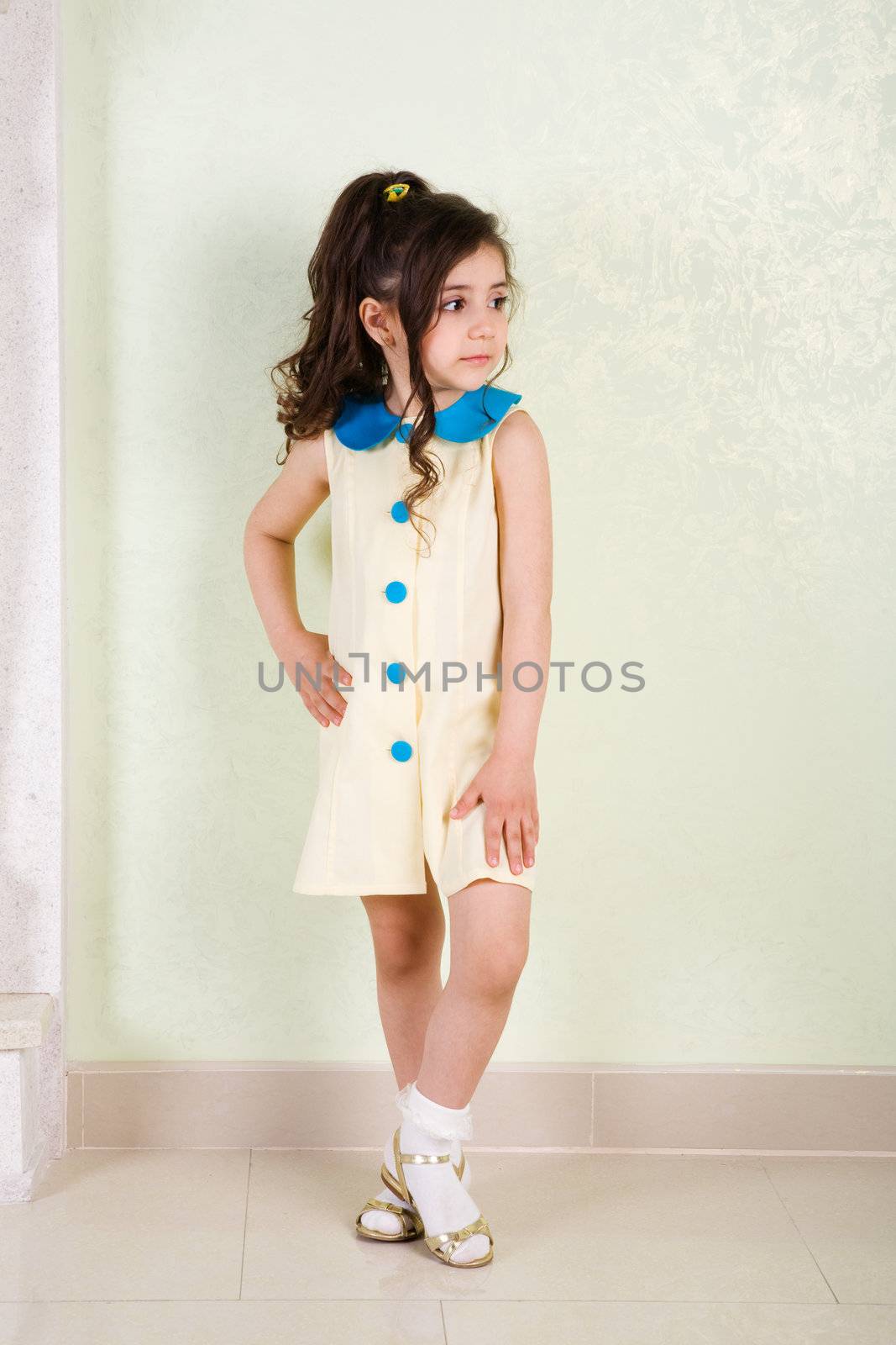 prett girl in yellow dress with blue buttons