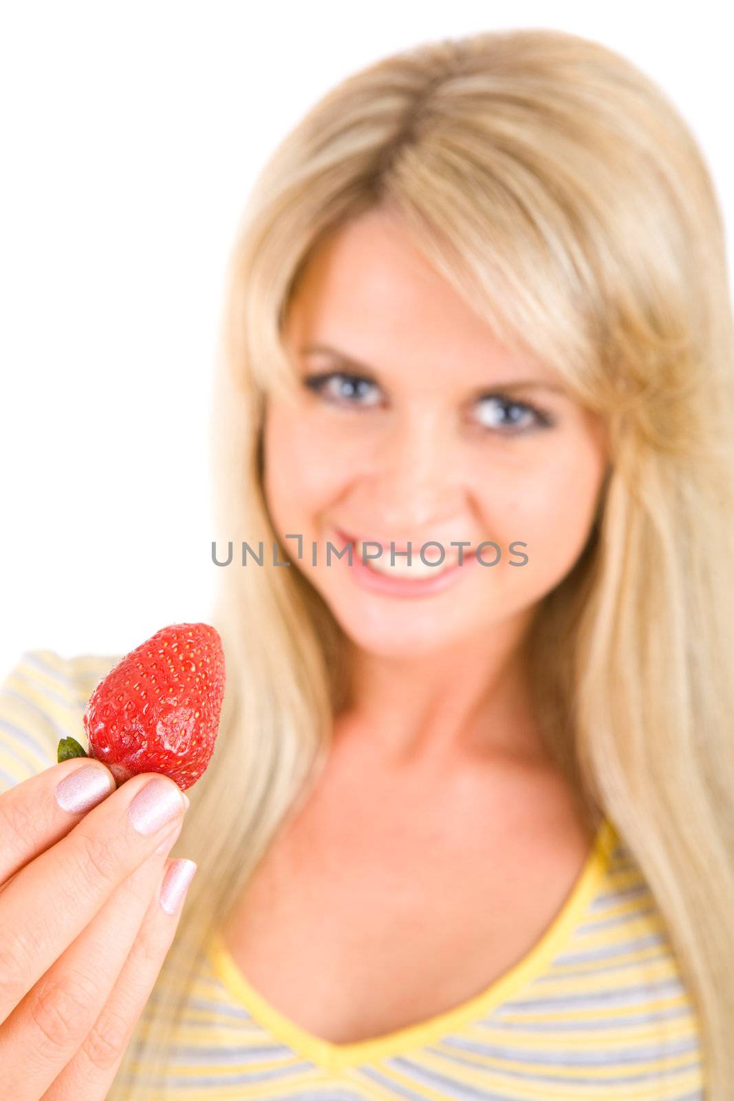 tasty strawberry in hands of the long haired beauty