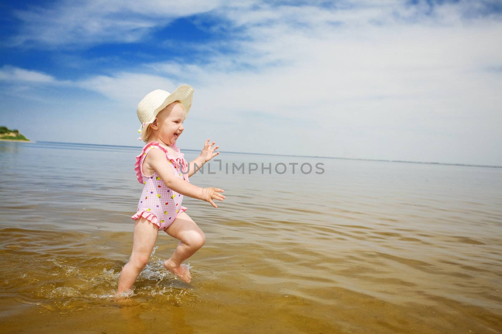 blue sky, water and running child by vsurkov