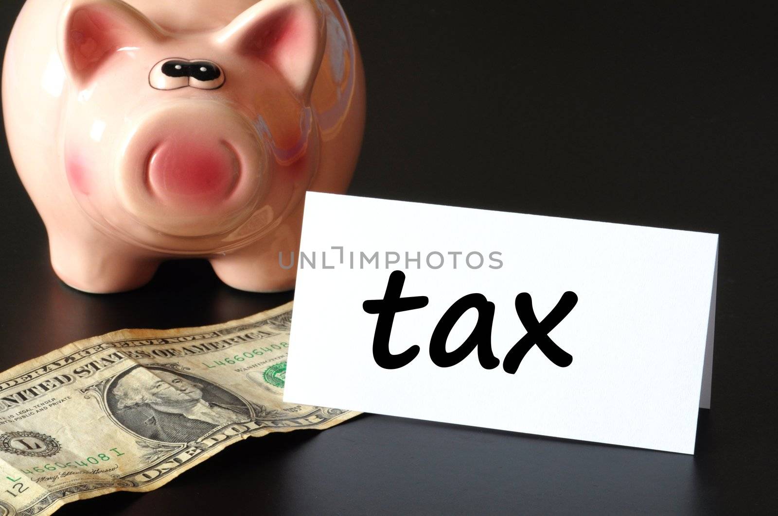 save tax concept with piggy bank and money on black