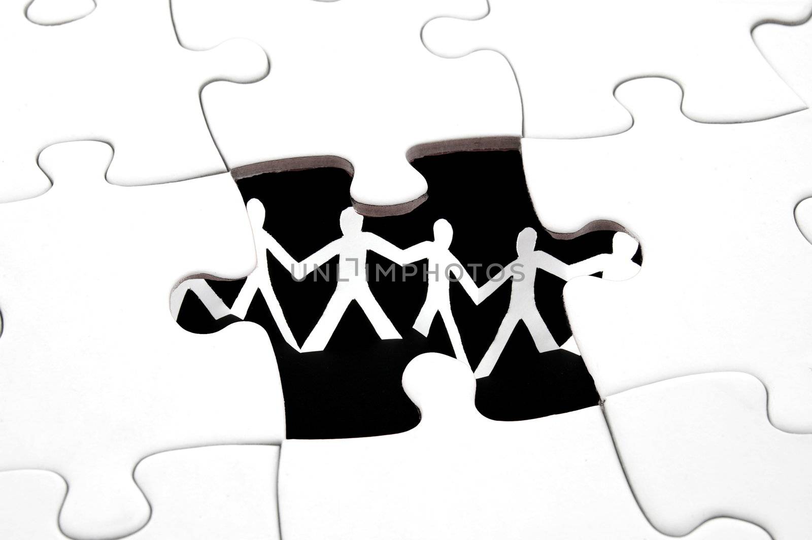 puzzle and paper man team showing teamwork concept