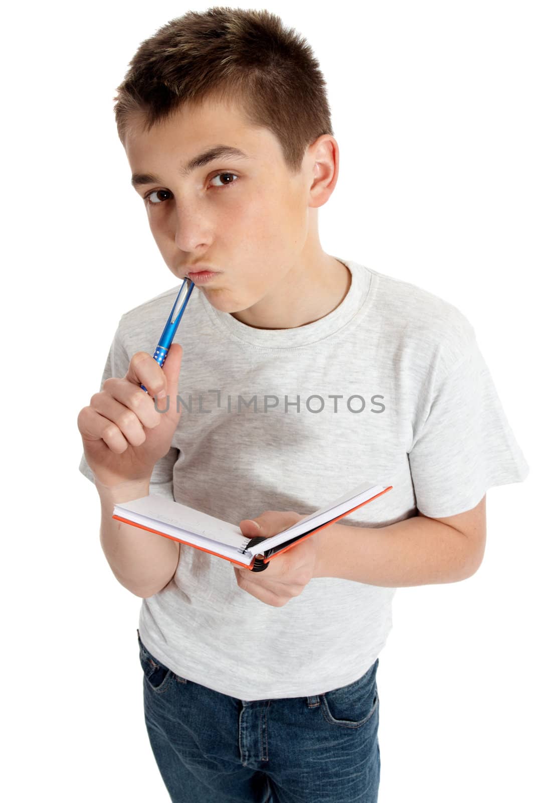 Student holding a book, pen and thinking intently.