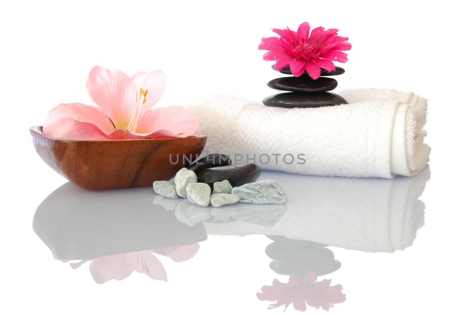 wellness zen and spa still life with flower towel and pebbles isolated on white