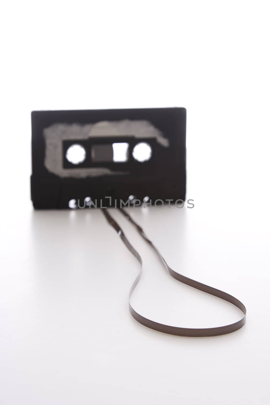 focus on the unrolled part on the tape of a old cassette with cover sticker rip apart