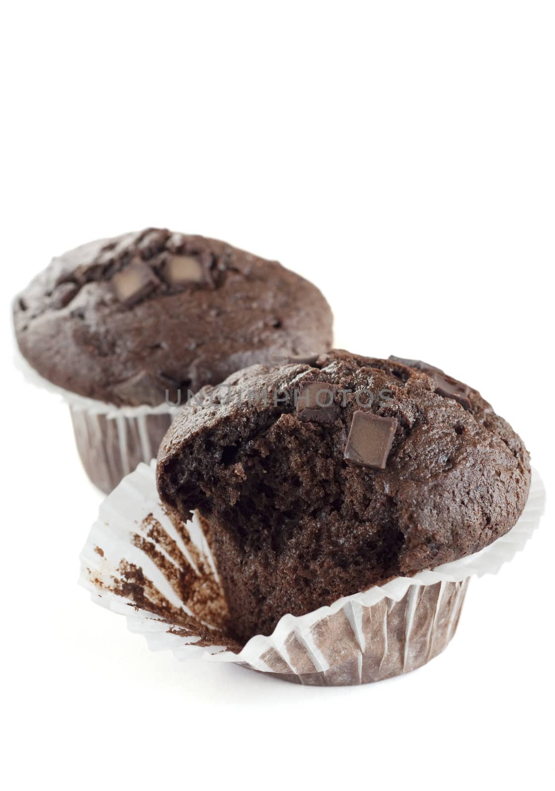 Two double chocolate muffins isolated on a white background