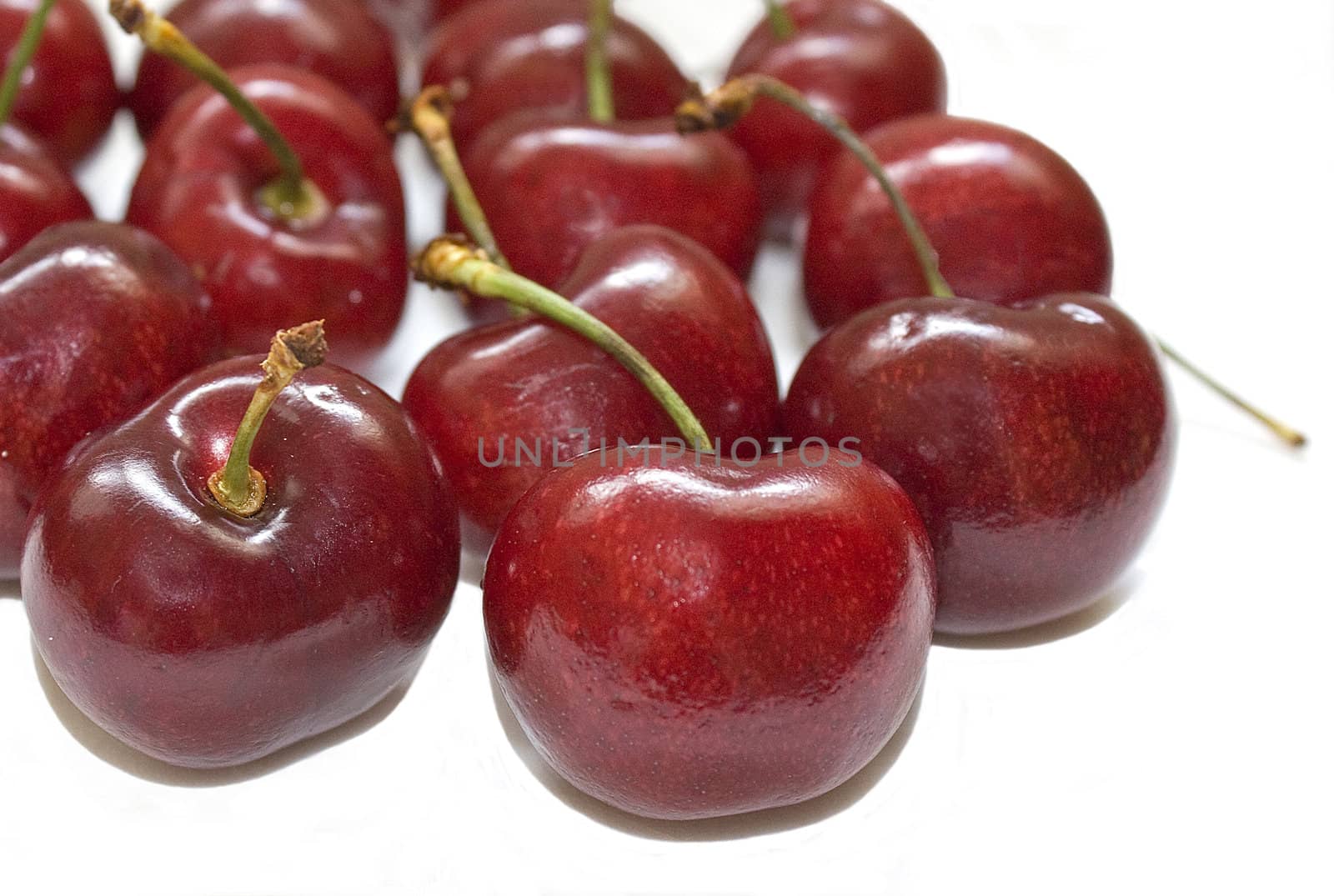 Several cherries isolated over a white background.